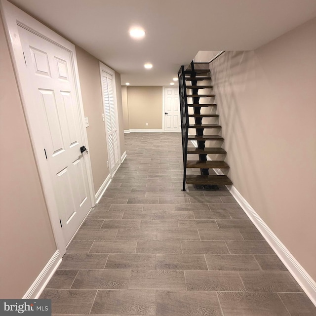 hall with baseboards, recessed lighting, stairs, and dark wood finished floors