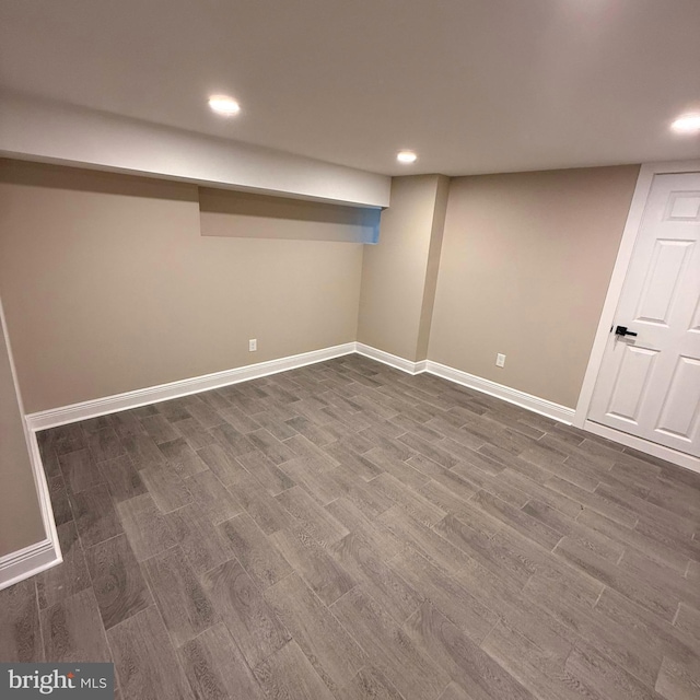finished basement featuring recessed lighting, baseboards, and dark wood-type flooring