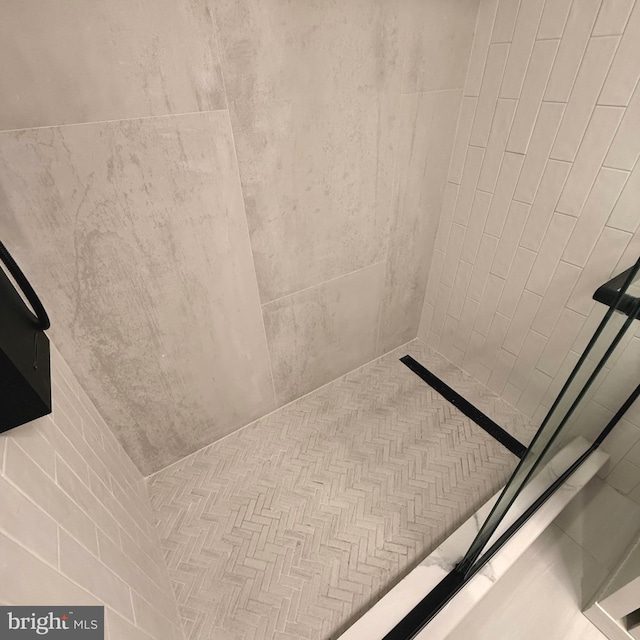 interior details featuring tiled shower