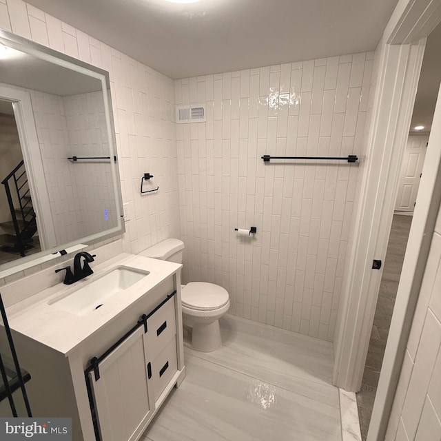 bathroom featuring toilet, visible vents, and vanity