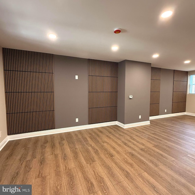 empty room featuring light wood-type flooring, recessed lighting, and baseboards