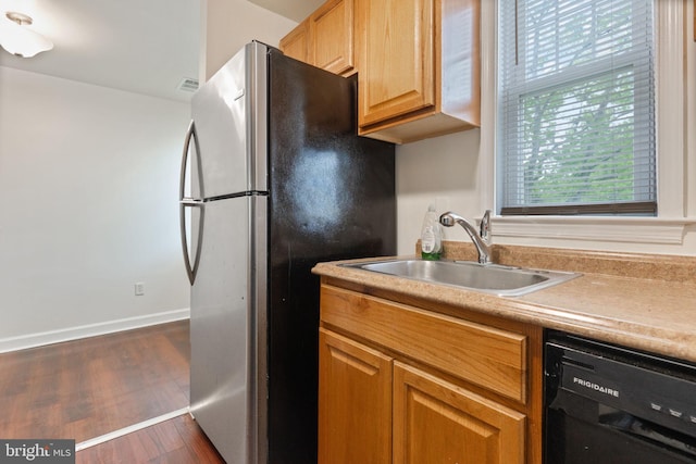 2512 Kent Village Dr, Landover, MD 20785 - kitchen featuring dishwasher, freestanding refrigerator, a sink, dark wood-style flooring, and light countertops