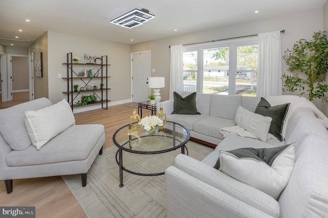 living room featuring light wood-style floors, recessed lighting, and baseboards