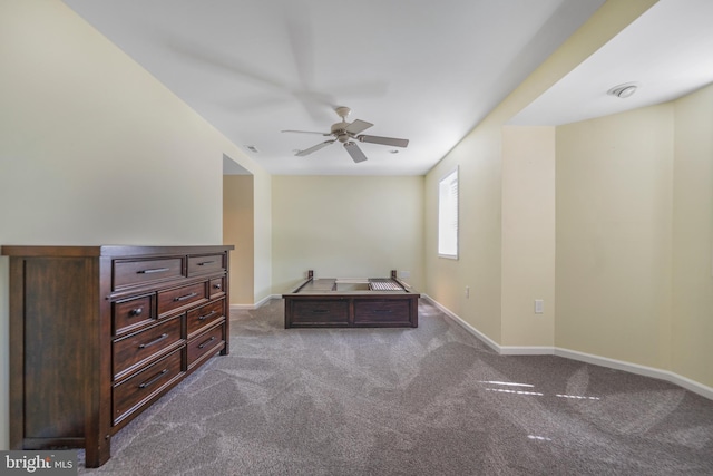 bedroom with dark colored carpet, baseboards, and ceiling fan