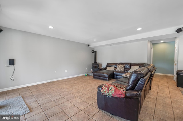 living area with light tile patterned flooring, recessed lighting, a wood stove, and baseboards