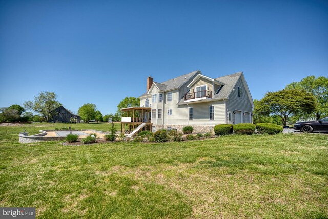 view of property exterior featuring stairway, a garage, a chimney, a lawn, and stone siding
