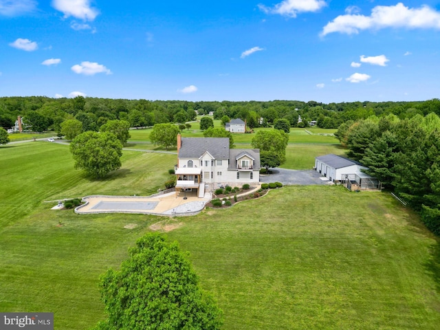 view from above of property with a tree filled landscape