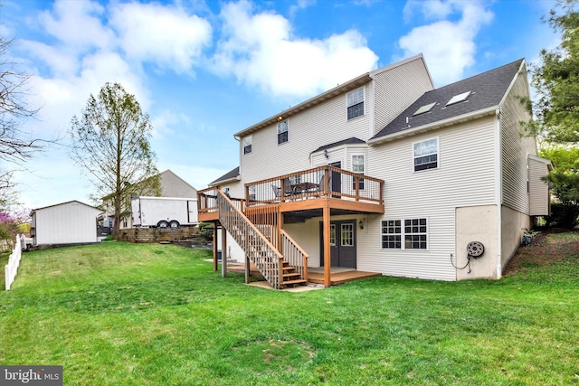 rear view of property with a lawn, stairs, and a deck