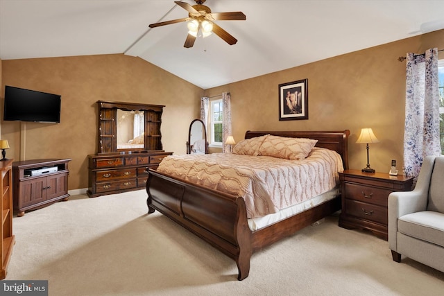 bedroom featuring ceiling fan, lofted ceiling, and light carpet