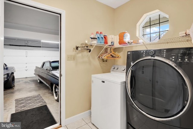 laundry room featuring baseboards, laundry area, and washer and dryer
