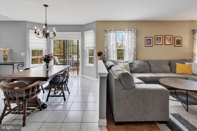 living area with light tile patterned floors and a chandelier