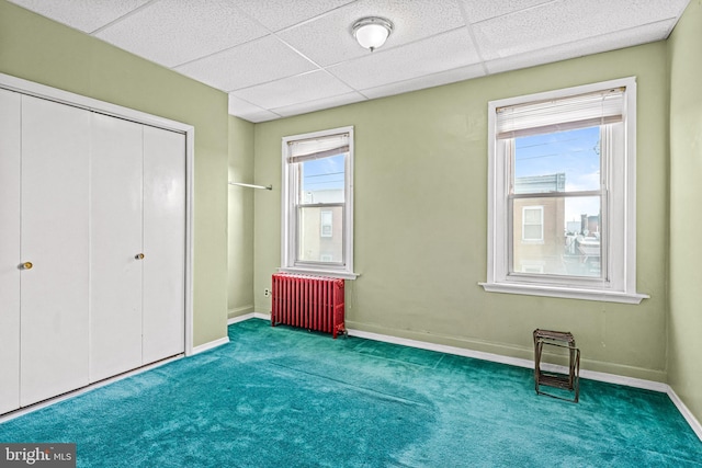 1741 Moore St, Philadelphia, PA 19145 - unfurnished bedroom featuring radiator, carpet flooring, baseboards, a closet, and a paneled ceiling