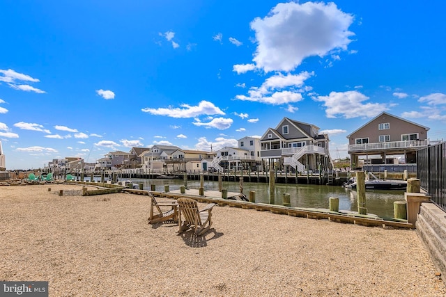 dock area featuring a water view and a residential view