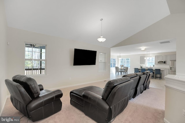 7438 Wildseed Pl, Hughesville, MD 20637 - living area featuring baseboards, high vaulted ceiling, visible vents, and light carpet