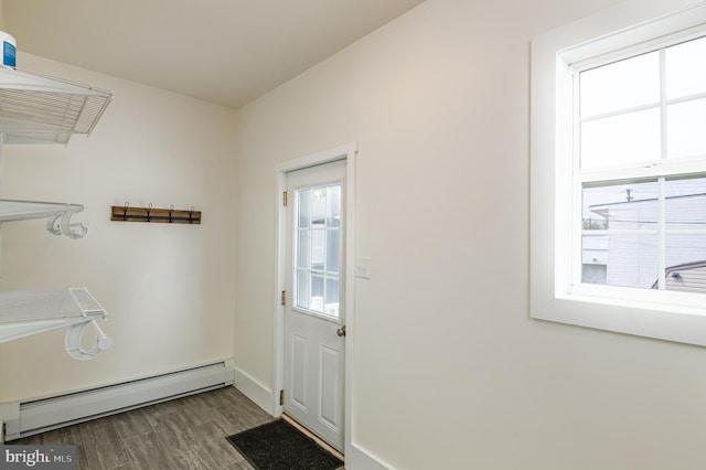 entryway with baseboards, dark wood-type flooring, and a baseboard radiator