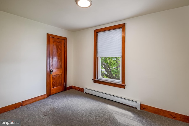 empty room with baseboards, carpet, and a baseboard heating unit