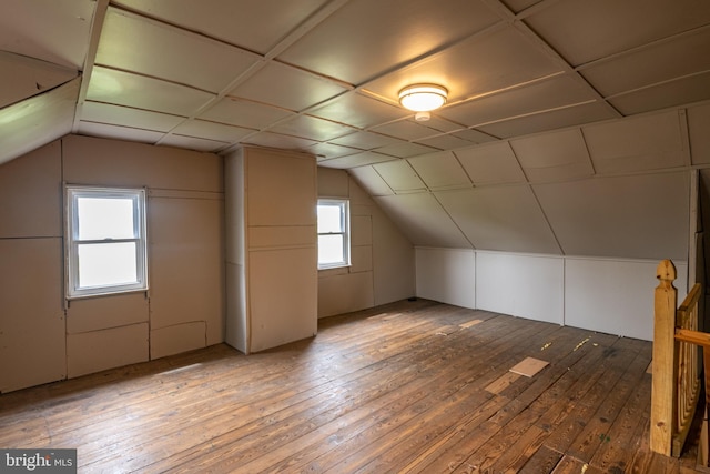 bonus room with lofted ceiling and hardwood / wood-style floors