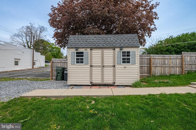 view of shed with fence