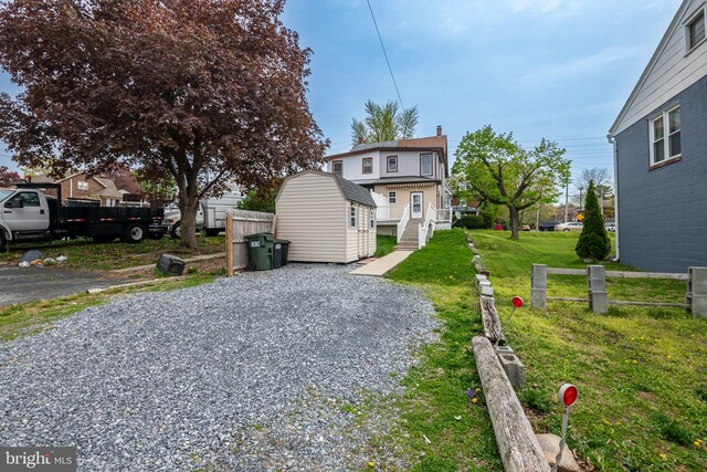 exterior space with a front lawn and gravel driveway
