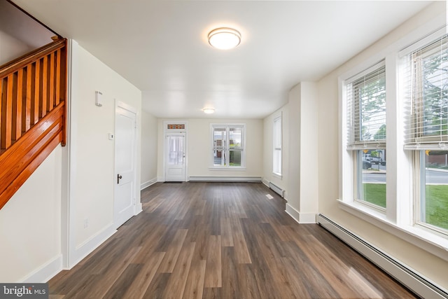 foyer entrance with baseboards, baseboard heating, a baseboard heating unit, and dark wood-style floors