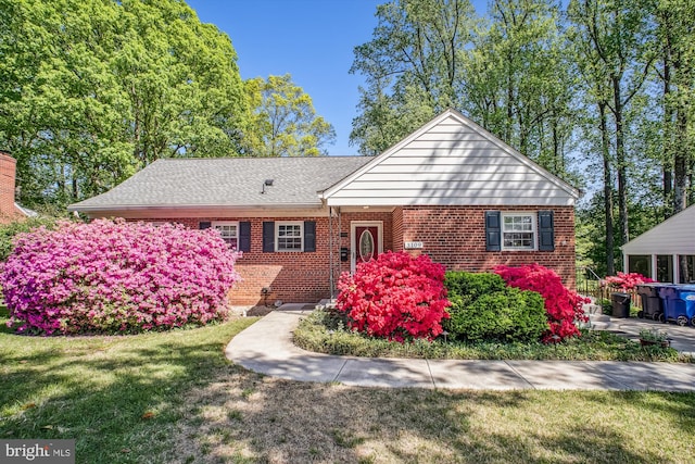 ranch-style home with brick siding and a front lawn