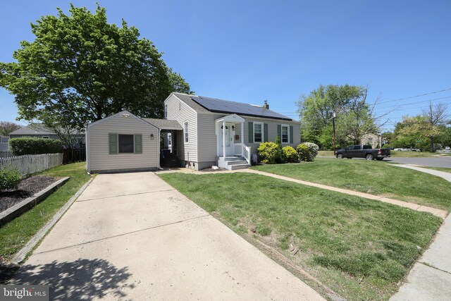 43 Churchill Rd, Cherry Hill, NJ 08034 - bungalow-style house featuring fence, concrete driveway, solar panels, and a front yard