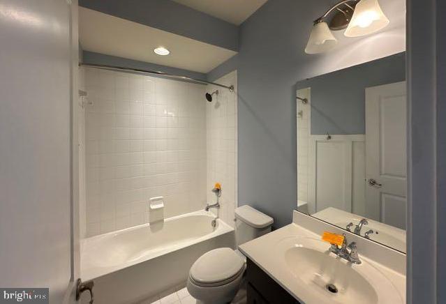 bathroom with toilet, tile patterned floors, shower / washtub combination, and vanity