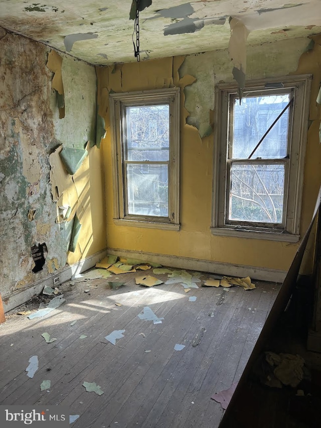 unfurnished room with wood-type flooring