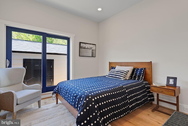 bedroom with recessed lighting, baseboards, and wood finished floors