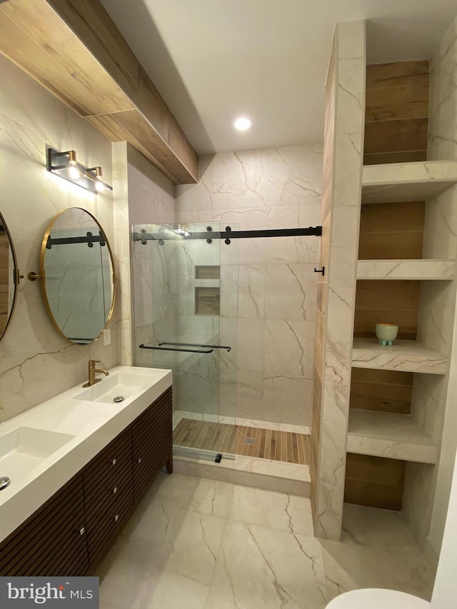 bathroom featuring recessed lighting, a sink, marble finish floor, and a marble finish shower