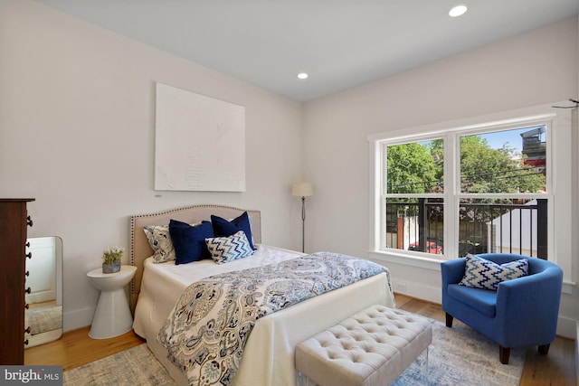 bedroom with recessed lighting and wood finished floors