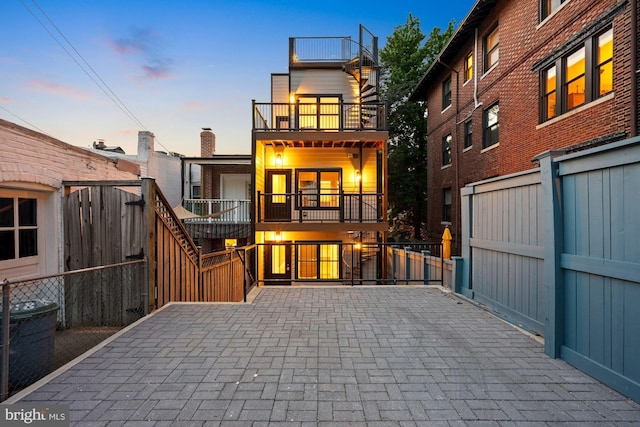 back of property featuring fence and a balcony