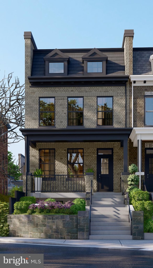 view of front of house featuring brick siding and covered porch