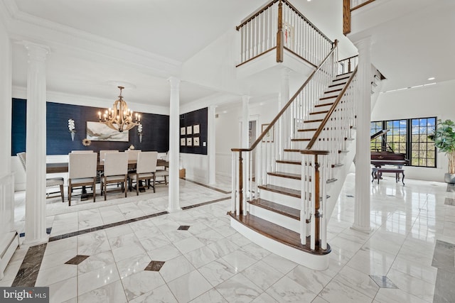 interior space with decorative columns, crown molding, marble finish floor, an inviting chandelier, and recessed lighting