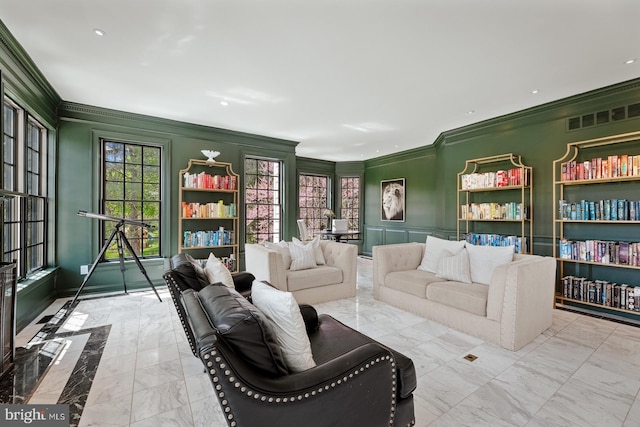 sitting room with visible vents, ornamental molding, marble finish floor, a decorative wall, and recessed lighting