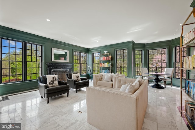 interior space featuring recessed lighting, ornamental molding, marble finish floor, and a fireplace