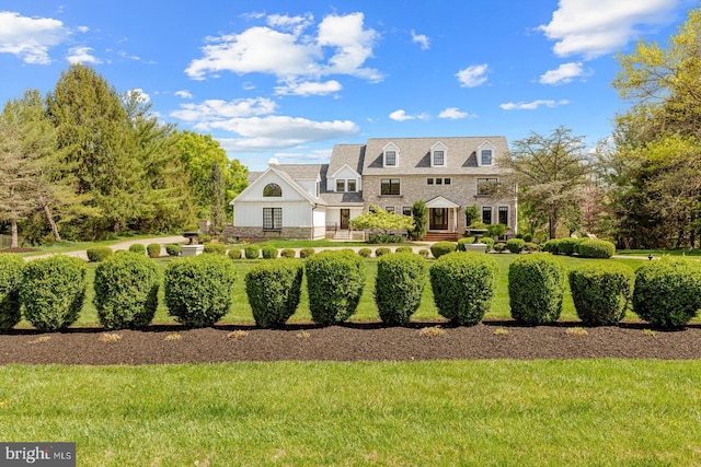 cape cod house with stone siding