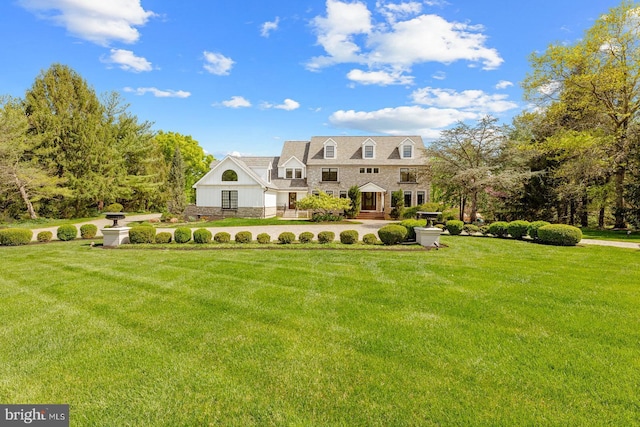 view of front of property with a front lawn and stone siding
