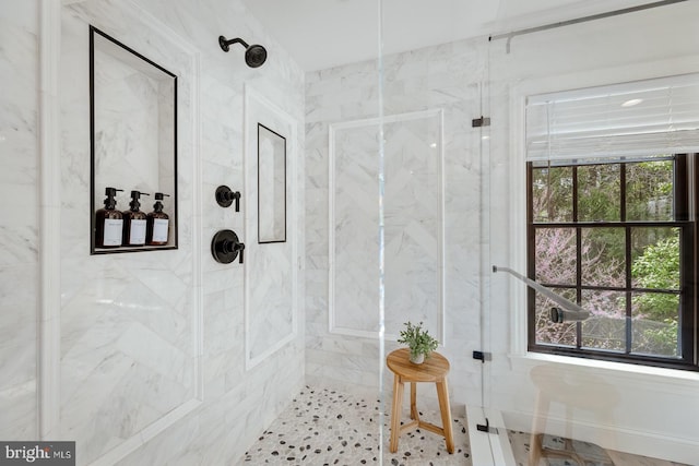bathroom with a marble finish shower