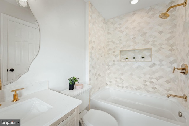 bathroom with washtub / shower combination, vanity, and toilet