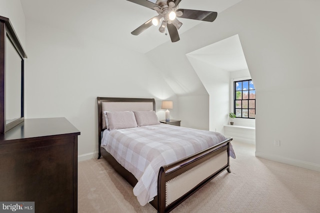 bedroom featuring baseboards, light colored carpet, ceiling fan, and vaulted ceiling
