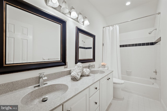 full bathroom featuring double vanity, toilet, a sink, and shower / bath combo