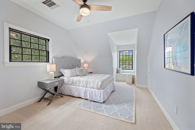 bedroom with carpet floors, baseboards, lofted ceiling, and visible vents