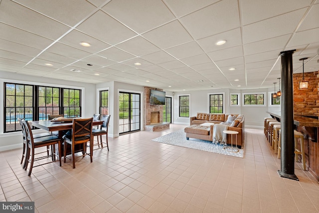 dining space with recessed lighting, baseboards, a drop ceiling, and light tile patterned floors