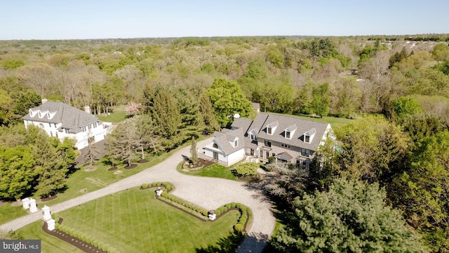 birds eye view of property with a wooded view