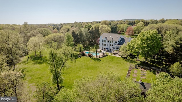 drone / aerial view with a wooded view