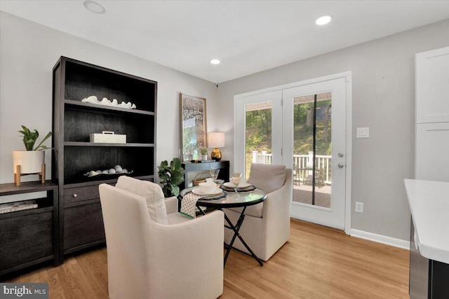dining room with recessed lighting, baseboards, and light wood-type flooring