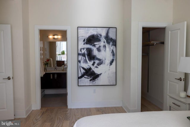 1421 Florida Ave NW Unit 5, Washington, DC 20009 - bedroom with light wood finished floors, a spacious closet, a closet, and baseboards