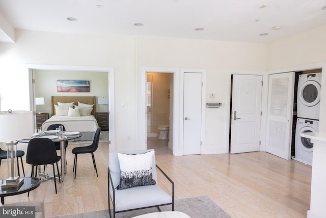 1421 Florida Ave NW Unit 5, Washington, DC 20009 - bedroom featuring stacked washing machine and dryer, light wood-style floors, and ensuite bath