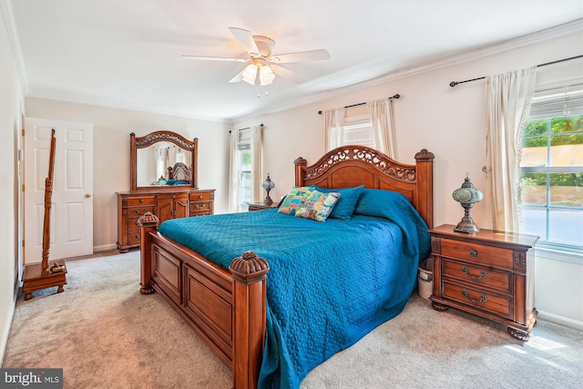 bedroom featuring light colored carpet, ornamental molding, baseboards, and a ceiling fan